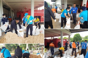 ด้วยช่วยกัน บรรจุกระสอบทราย เพื่อเตรียมการป้องกันภัยน้ำท่วม ในช่วงที่มีพายุเข้าอย่างต่อเนื่อง